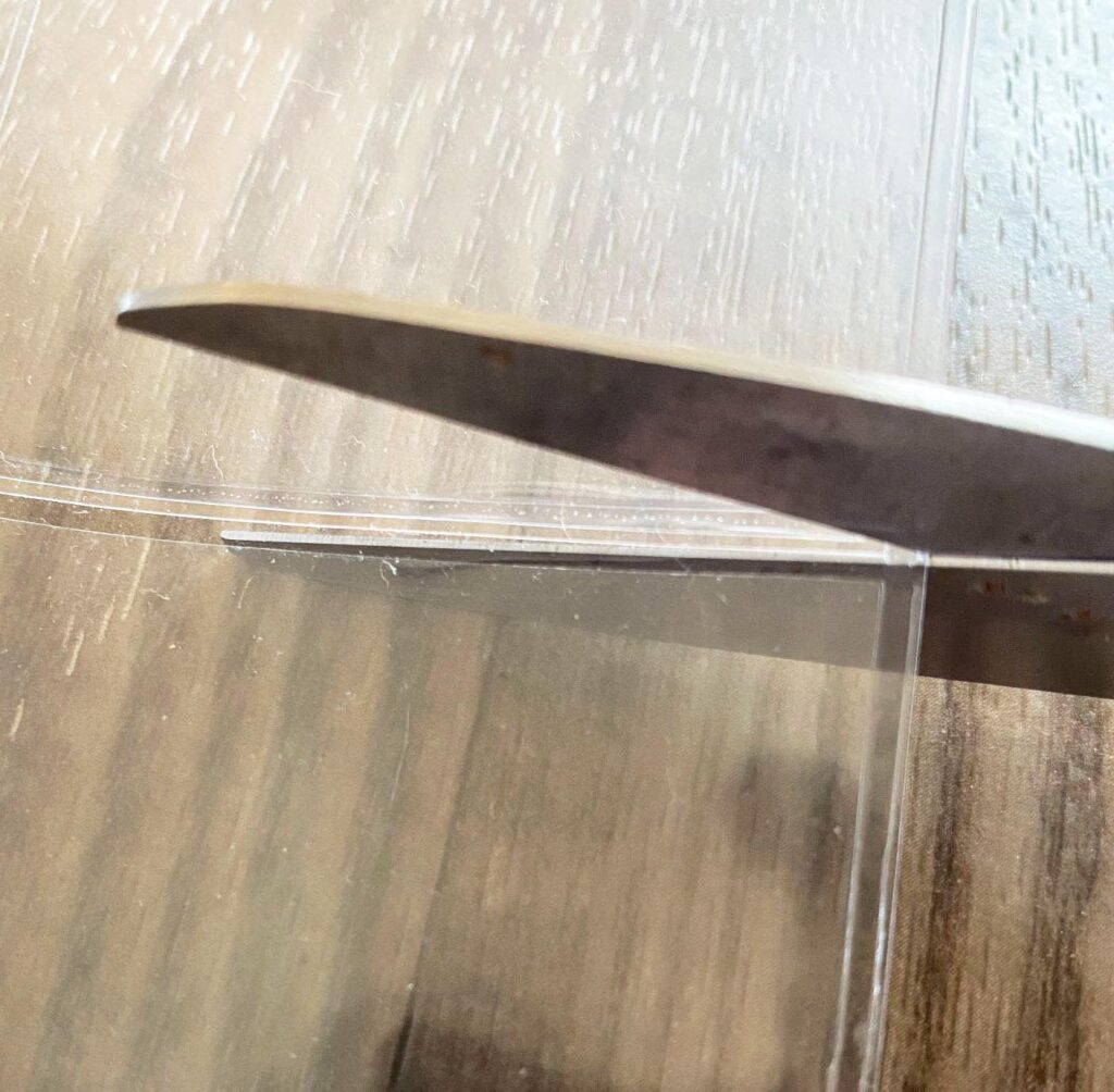 Scissors cutting a 9-pocket card page