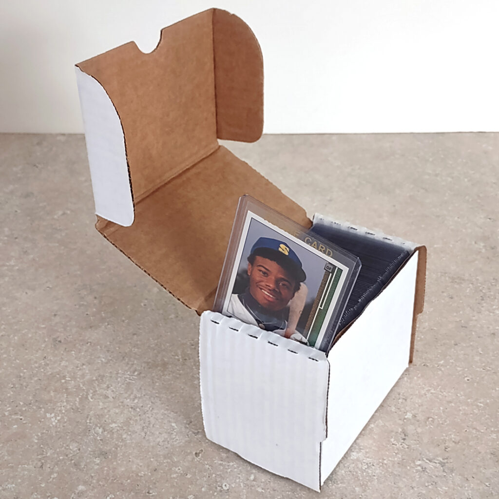 A small box designed to hold toploaders filled with cards.